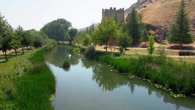 Ucero river passing quietly next to the wall of the medieval city of Burgo de Osma, Soria.