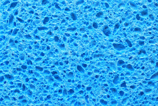 Blue color porous cleaning sponge texture as background