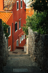 Old narrow street of historic town Mali Lošinj on coast of Adriatic sea on Croatia island Lošinj