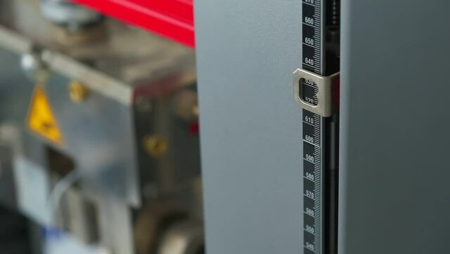 Ruler on testing laboratory machine in testing process, slow motion