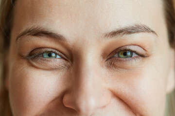 Close-up laughing eyes of a young beautiful woman