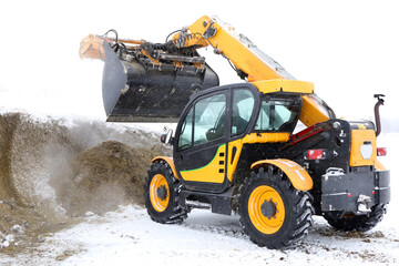 Bucket with Emily mobile cutter. Selection of silage and haylage from silage and haylage trenches. Fodder for animals in winter.