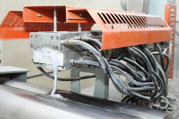 Machine for the production of powder paint. A layer of plastic is cut, crushed and a special paint is produced.