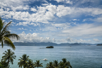 A summer day with blue sky and a boat cruising the bay of Angra dos Reis, State of Rio de Janeiro,...
