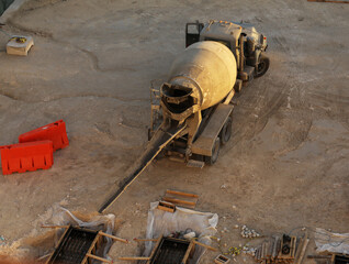 Mixer truck is transport cement to the casting place on building site,Selective focus.Concrete is...