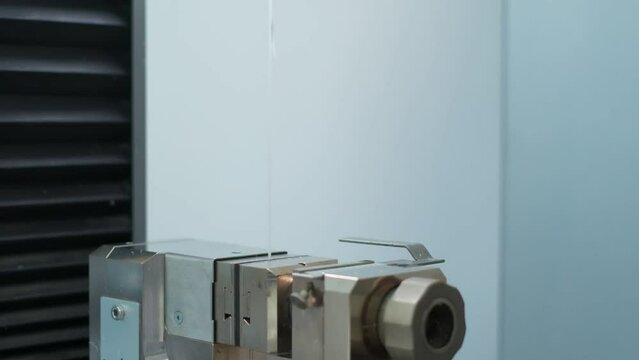 Polymer thread for plastic sack bags is tested for strength in laboratory, slow motion