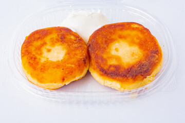 Food delivery to the office. Appetizing Ukrainian cheesecakes, pancakes.