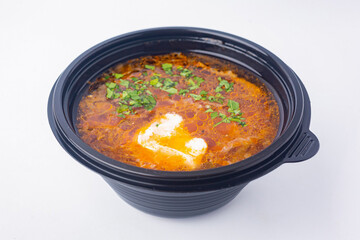 Food delivery to the office. Appetizing Ukrainian borscht with sour cream, a national dish.