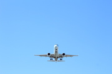 Fototapeta na wymiar Twin-engine aircraft landing on a clear, sunny day. 