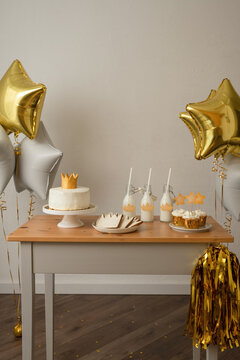 Table with cake, milkshake and cupcakes