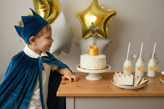 Blond boy prepare to blow out candles at a birthday party