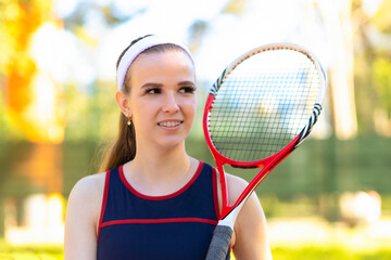 Professional girl athlete playing tennis on court. female player with racket, ball near net...