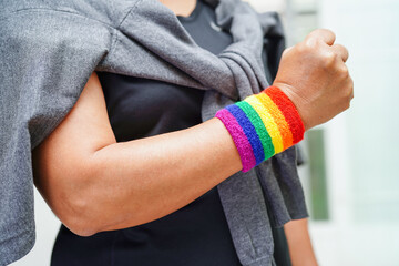 Asian woman with rainbow flag, LGBT symbol rights and gender equality, LGBT Pride Month in June.