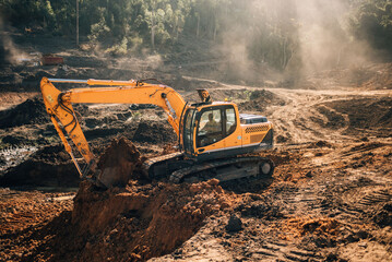 Excavator & Digger working on a new construction & Dam with gravel & Dust
