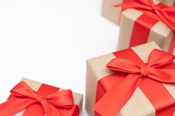 Close-up brown paper gift box red bow ribbon white background. concept for happy love gift