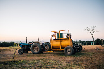 Fototapeta na wymiar Tractor & water tank on agricultural farm