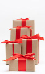 Close-up brown paper gift box red bow ribbon white background. concept for happy love gift