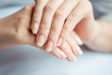 Close-up of healthy female fingernails. Nail health care concept.