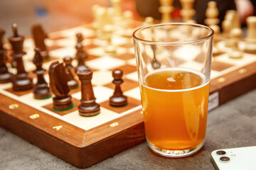 The beer glass and chess board in the bar.