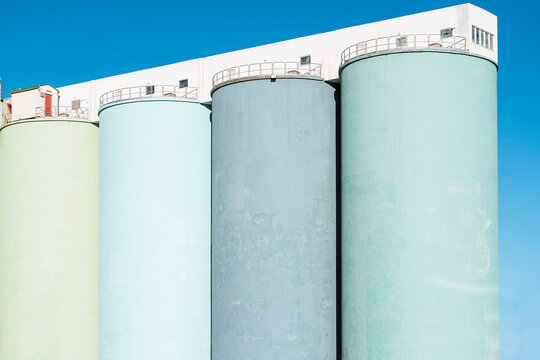 Large oil tanks under blue sky in sunlight