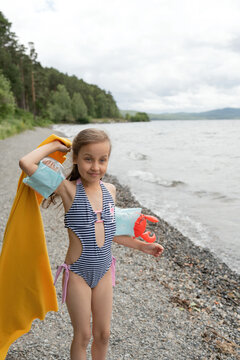 Girl having fun on the seashore on a cloudy day