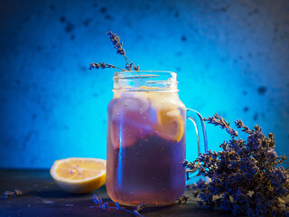 Glass mug with craft lavender lemonade. Refreshing summer cold drink with lavender syrup and lemon...