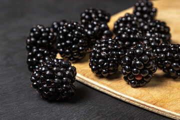 Blackberry on a black background. Healthy and tasty berry