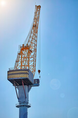 Naklejka premium Port tower crane against a blue sky.