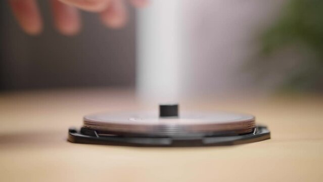 Open a box of DVD or CD media packaging with hands 4K