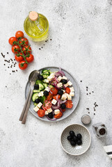 Greek salad with feta cheese, olives and olive oil on a stone background. Appetizer with cheese.