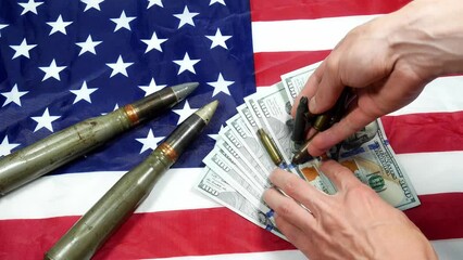 American flag with dollars money, bullets, shells, cartridges and projectiles on it. Lend-Lease concept. Army concept. Sales of weapons and ammunition. Military industry, war, global arms trade.
