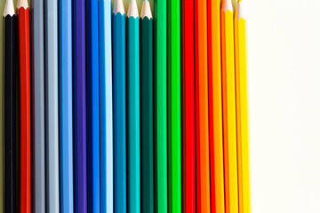 A large number of sharpened colored pencils with falling shadow from natural light on a bright...