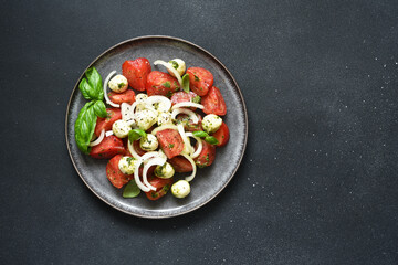 Mix salad with mozzarella, tomatoes and pesto sauce. Caprese appetizer with pesto...
