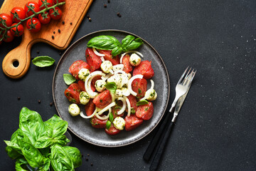 Mix salad with mozzarella, tomatoes and pesto sauce. Caprese appetizer with pesto...