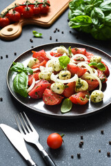 Mix salad with mozzarella, tomatoes and pesto sauce. Caprese appetizer with pesto...