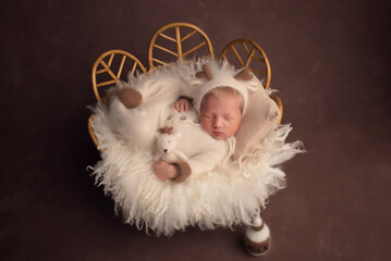 Beautiful newborn baby sleeps with knitted toys