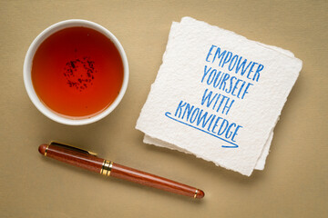 empower yourself with knowledge - inspirational writing on a napkin, flat lay with tea, education and personal development concept