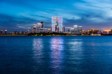 City skyline and modern commercial buildings in Suzhou at sunset, China.