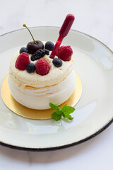 pavlova dessert with berries and cream