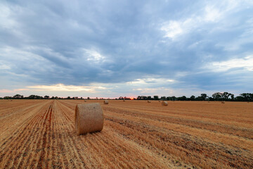 Hay bale in the field with dramatic overcast cloudy sky