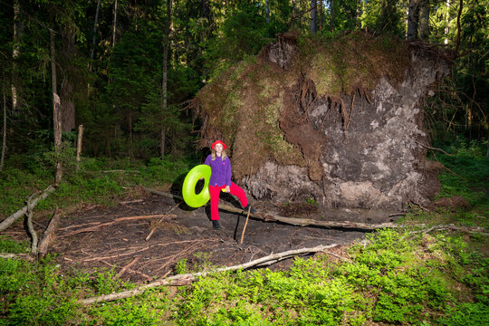 Woman with inflatable ring standing in forest