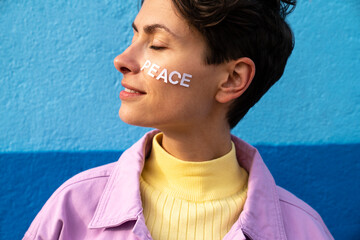 Woman with peace text on cheek