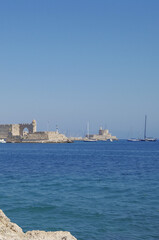 Fototapeta premium Picturesque scenic narrow alleys with traditional cobblestone streets and Souvenir shops in Old Town of Rhodes City in famous tourist attraction Rhodes island in Dodekanes Greece during Summer cruise