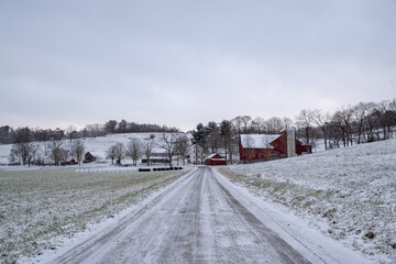 Snowy country road leading to an Amish farm in the countryside of Holmes county, Ohio