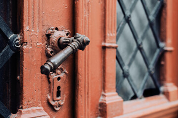 Vintage door handle design and entrance made of wood, iron and glass