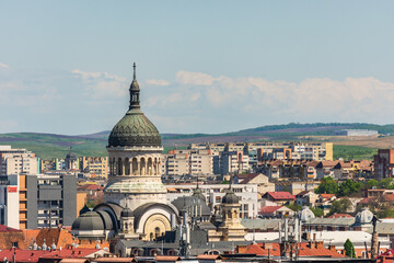 Fototapeta na wymiar Orthodox cathedral or church from Cluj Napoca saw from an aerial cityscape with many vintage buildings among communist constructions
