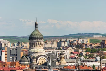 Deurstickers Orthodox cathedral or church from Cluj Napoca saw from an aerial cityscape with many vintage buildings among communist constructions © madrolly