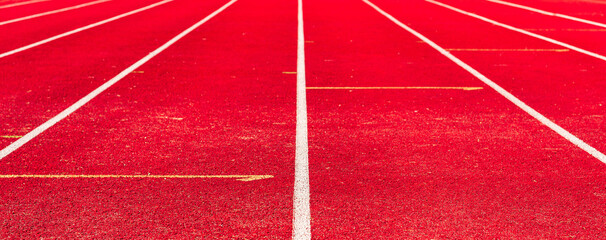 Athletic track,red surface and white lines closeup.Banner.