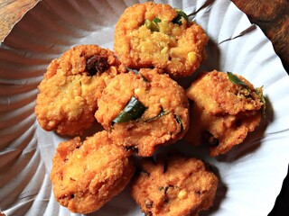 Close-up of home-made Parippu Vada/Dal Vada/Lentil fritters in a paper plate