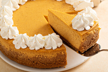 Pumpkin cheesecake with fall spices topped with whipped cream